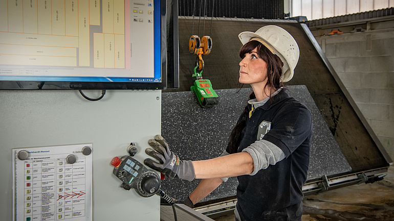 Frau mit Helm und Handschuhen im Betonhandwerk